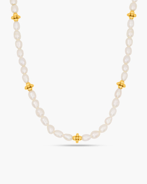Pearl necklace with gold beads on a white background